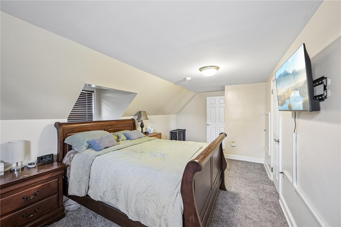 4065 Airport Road Allentown, PA 18109 - Photo 17 of 28 Attic bedroom with unique sloped ceilings and plush carpeting provides a comfortable retreat.