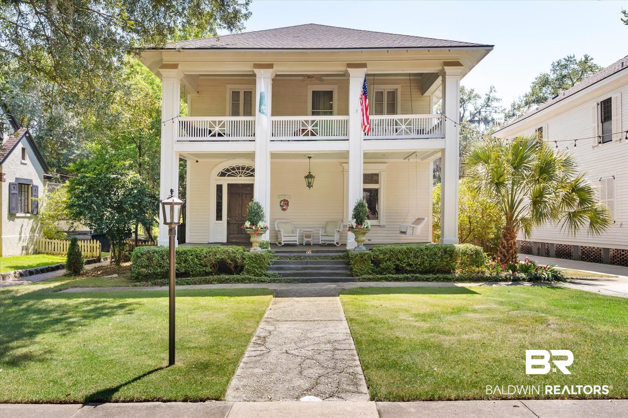 68 North Monterey Street Mobile, AL 36604 - Photo 1 of 30 View of front facade featuring a balcony, a front yard, and a porch