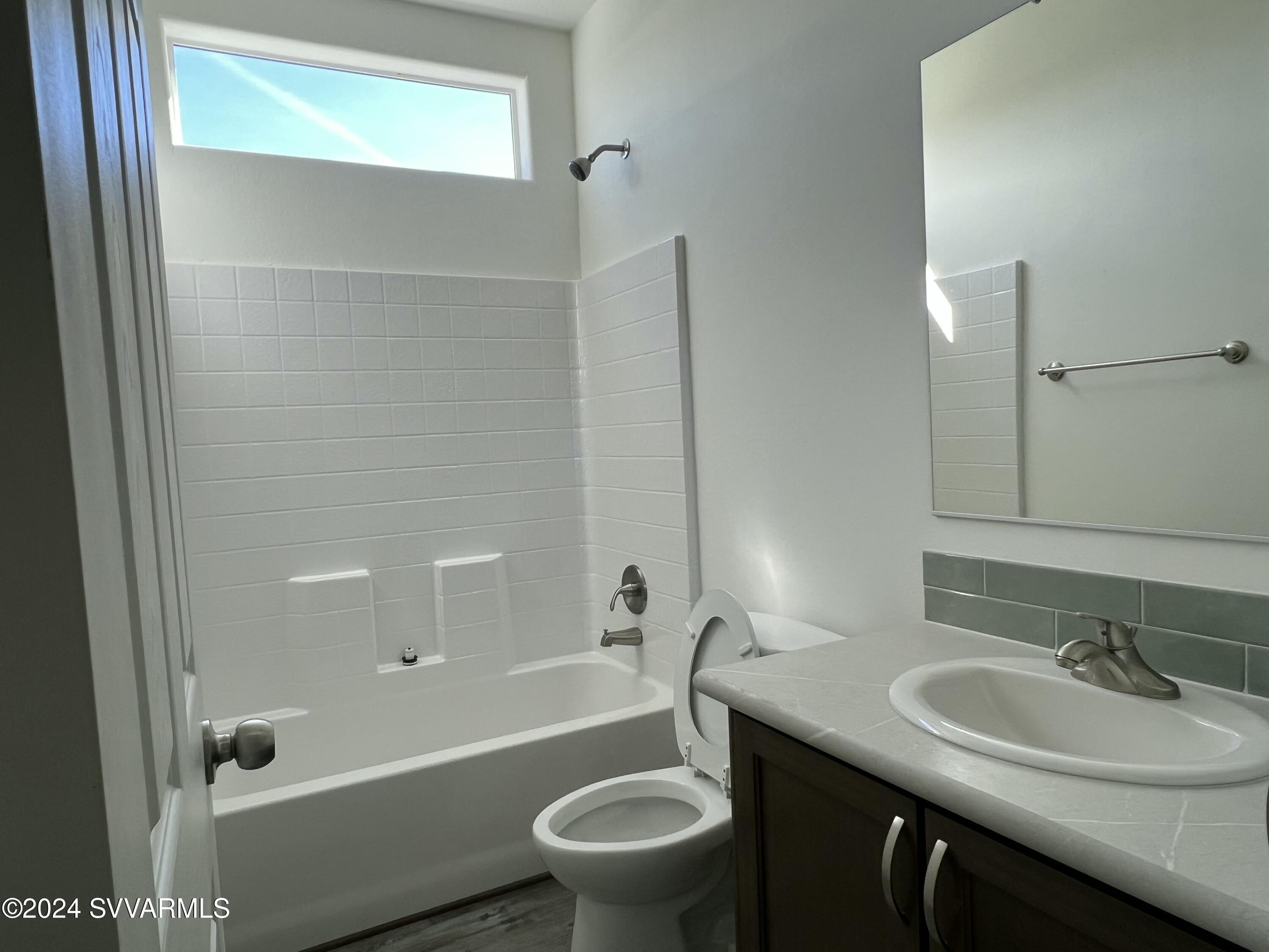 1058 West Rustic Pine Road Camp Verde, AZ 86322 - Photo 19 of 25 a bathroom with a sink a toilet and shower