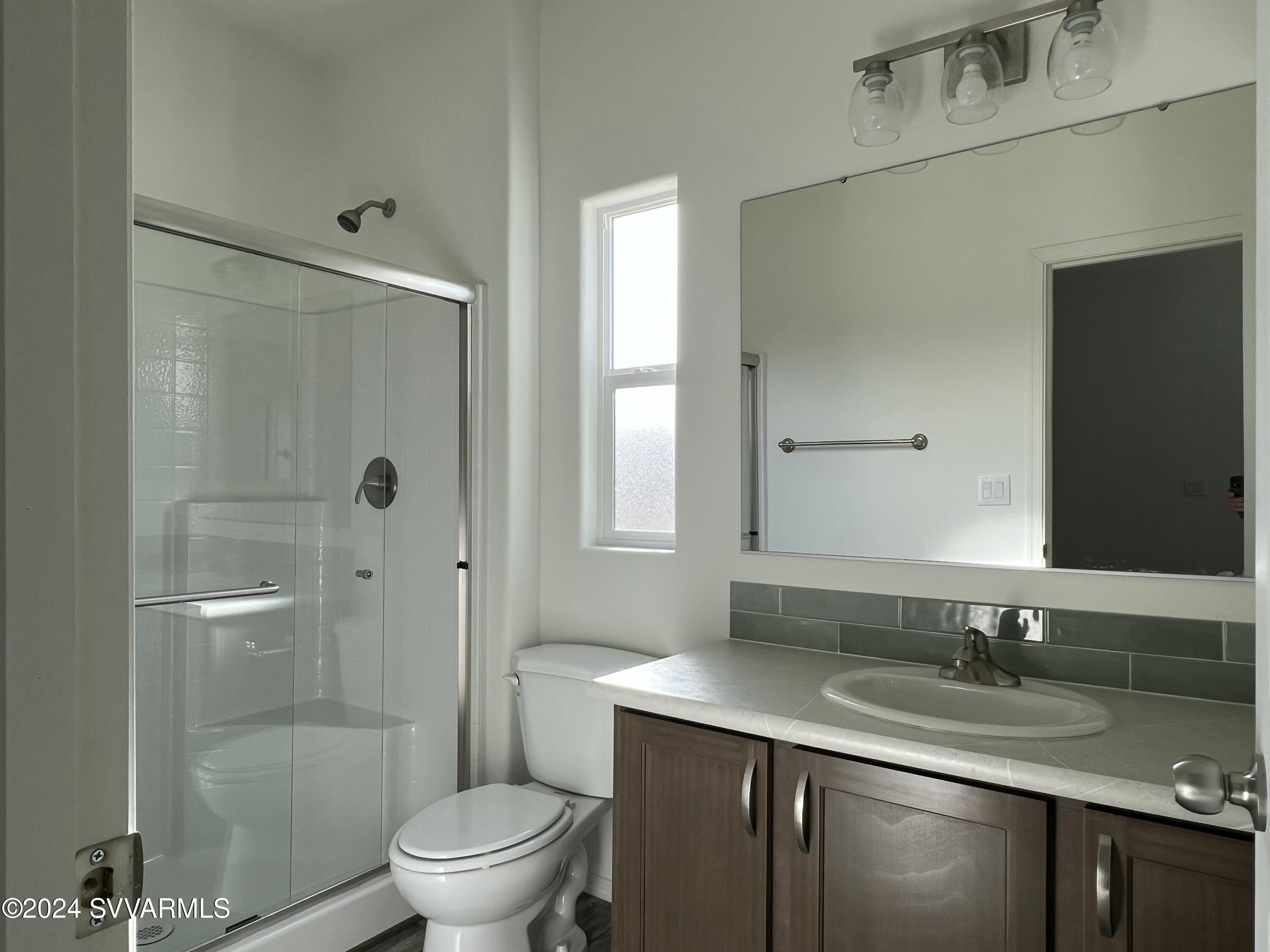 1058 West Rustic Pine Road Camp Verde, AZ 86322 - Photo 21 of 25 a bathroom with a granite countertop sink a toilet and shower