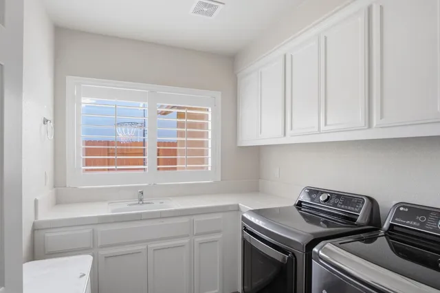 a kitchen with a sink stove and cabinets