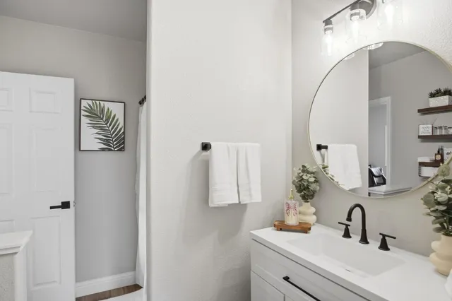 a bathroom with a sink and mirror