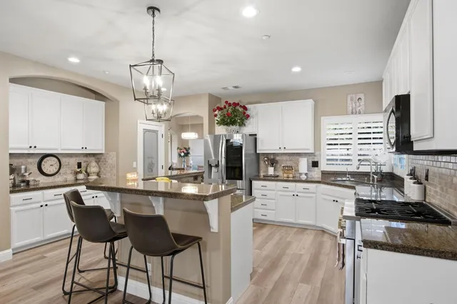 a kitchen with sink stove and cabinets