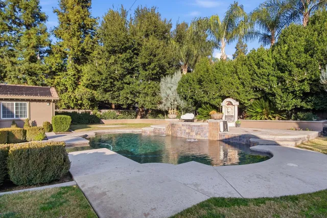 a view of a house with swimming pool yard and sitting area