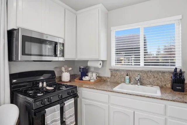 a spacious bedroom with a bed and a flat screen tv