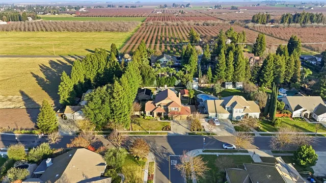 an aerial view of residential houses with outdoor space and parking