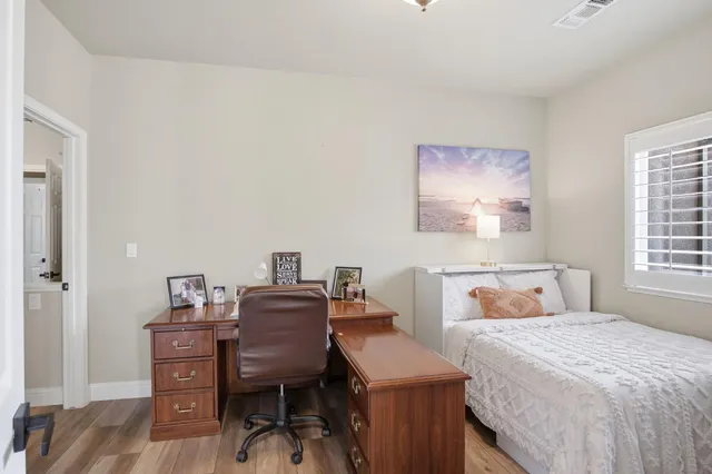 a bedroom with a bed and a desk