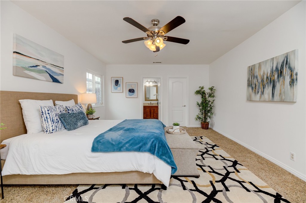 3816 Chatwin Avenue Long Beach, CA 90808 - Photo 12 of 60 a bedroom with a large bed and a chandelier