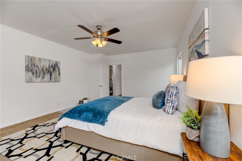 3816 Chatwin Avenue Long Beach, CA 90808 - Photo 15 of 60 a bedroom with a bed and a chandelier