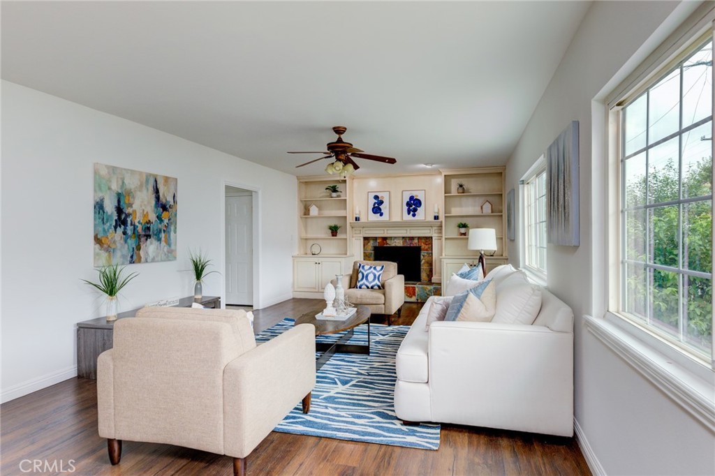 3816 Chatwin Avenue Long Beach, CA 90808 - Photo 26 of 60 a living room with furniture large window and a fireplace