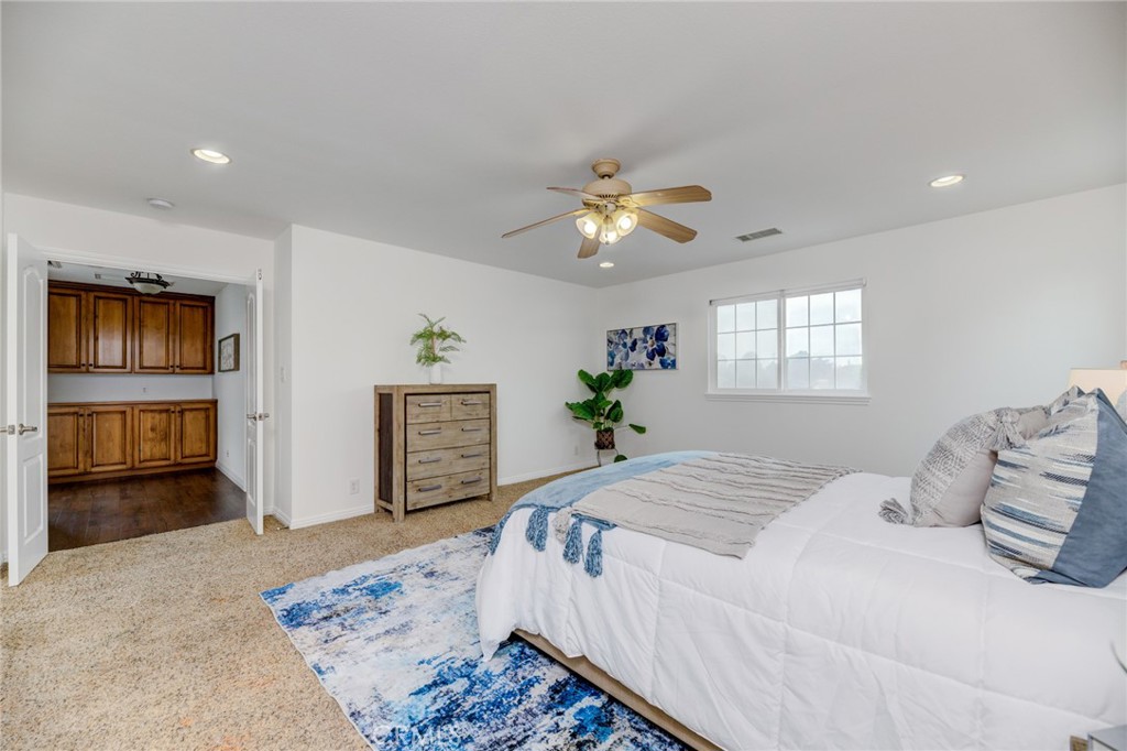 3816 Chatwin Avenue Long Beach, CA 90808 - Photo 43 of 60 a bedroom with a large bed and a chandelier