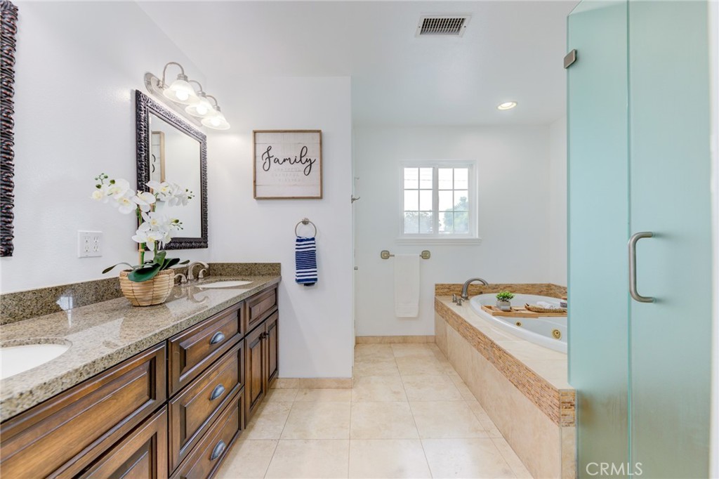 3816 Chatwin Avenue Long Beach, CA 90808 - Photo 45 of 60 a spacious bathroom with a granite countertop double vanity sink a mirror and a