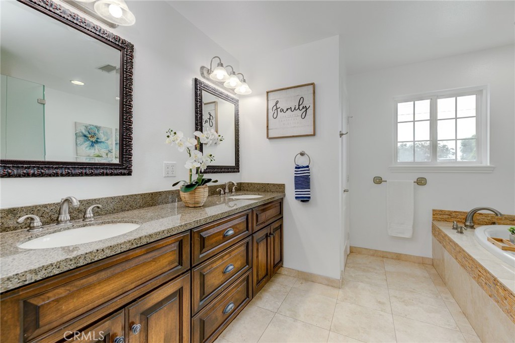 3816 Chatwin Avenue Long Beach, CA 90808 - Photo 46 of 60 a spacious bathroom with a granite countertop double vanity sink a mirror and a bathtub