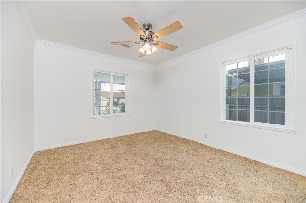 3816 Chatwin Avenue Long Beach, CA 90808 - Photo 9 of 60 an empty room with window and ceiling fan