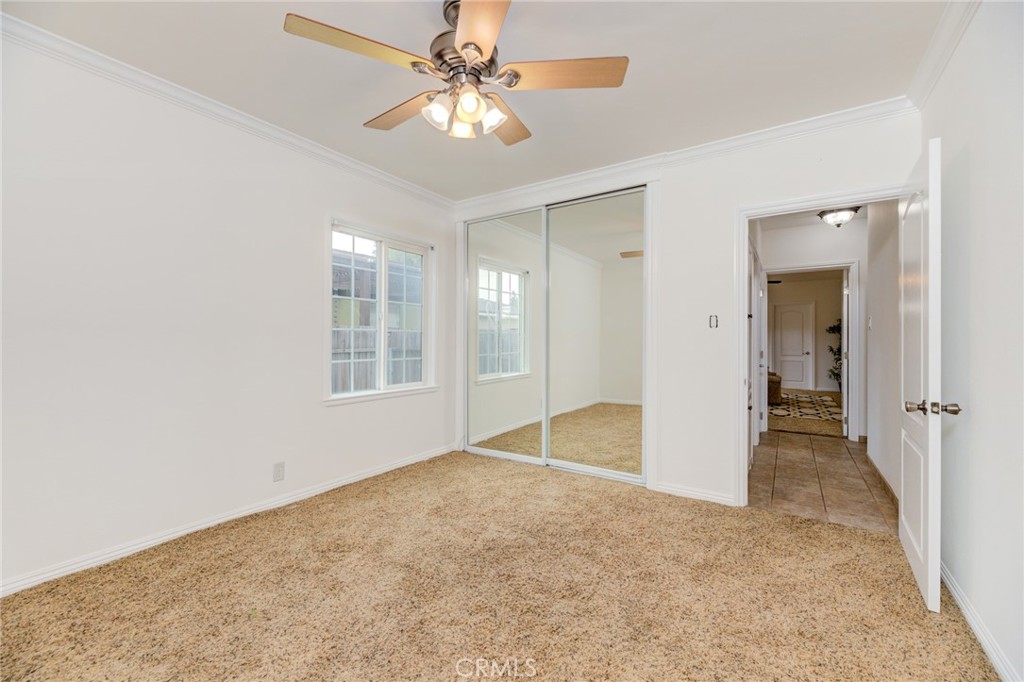 3816 Chatwin Avenue Long Beach, CA 90808 - Photo 10 of 60 an empty room with chandelier fan and windows