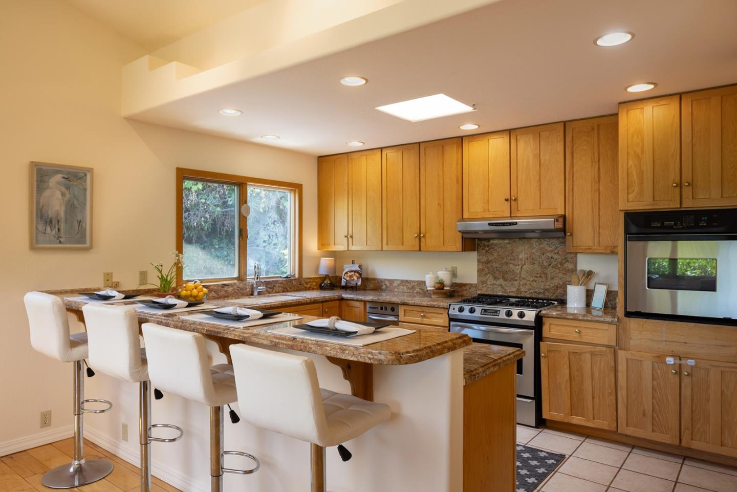 27461 Schulte Road Carmel, CA 93923 - Photo 11 of 33 a kitchen with a stove a sink a refrigerator and cabinets