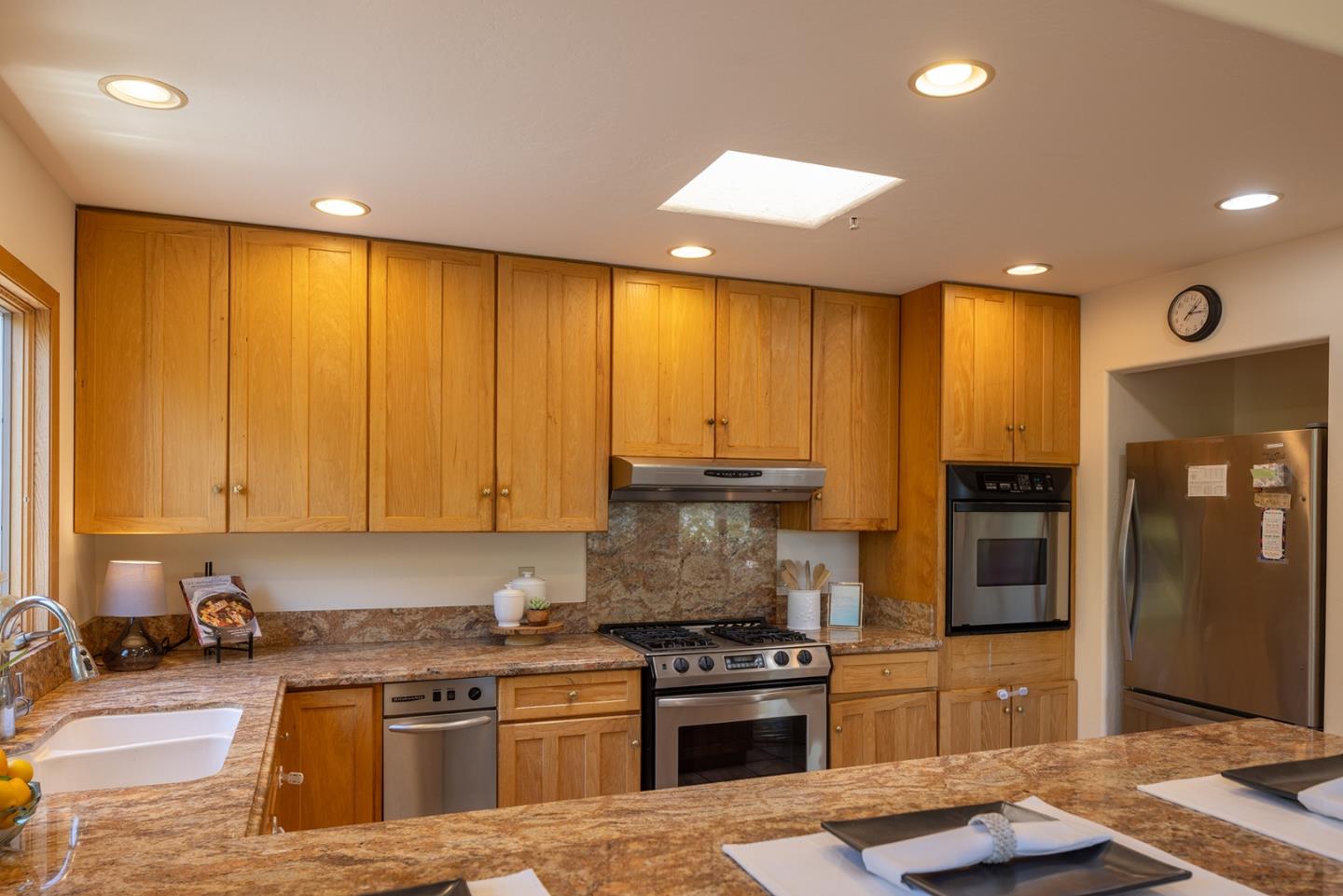 27461 Schulte Road Carmel, CA 93923 - Photo 12 of 33 a kitchen with stainless steel appliances granite countertop a stove a sink a refrigerator and a microwave