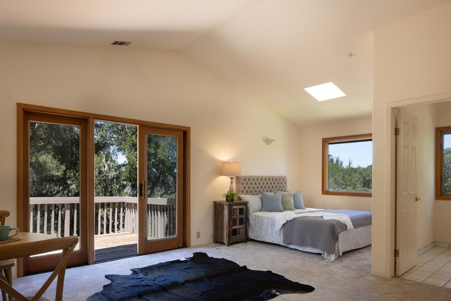 27461 Schulte Road Carmel, CA 93923 - Photo 27 of 33 a bedroom with a bed and a large window