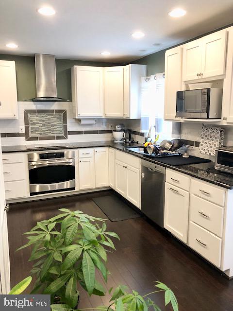 15 Robin Ridge Court Parkville, MD 21234 - Photo 5 of 15 a kitchen with stainless steel appliances a stove a sink a counter top space cabinets and a window