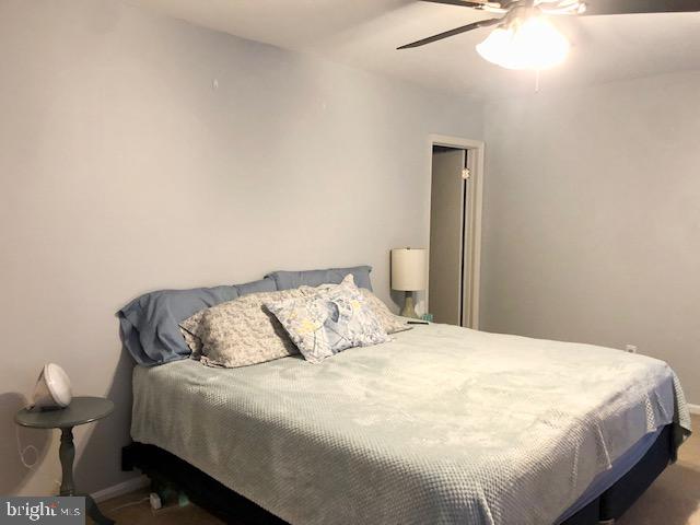 15 Robin Ridge Court Parkville, MD 21234 - Photo 9 of 15 a bedroom with a bed and a chandelier