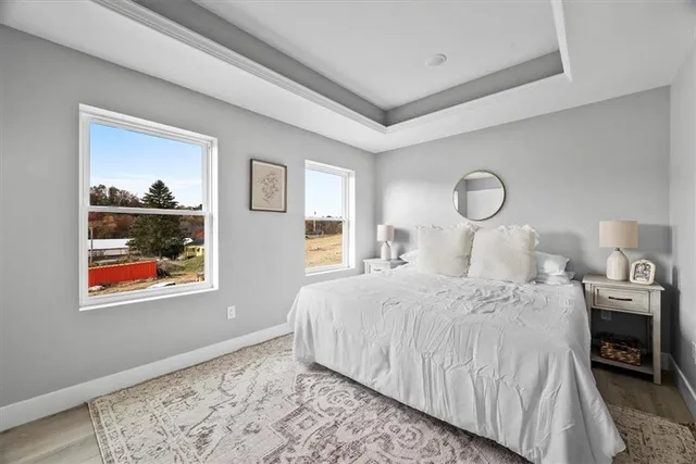 a bedroom with bed and wooden floor
