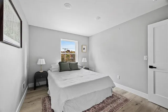 a bedroom with a bed and a lamp