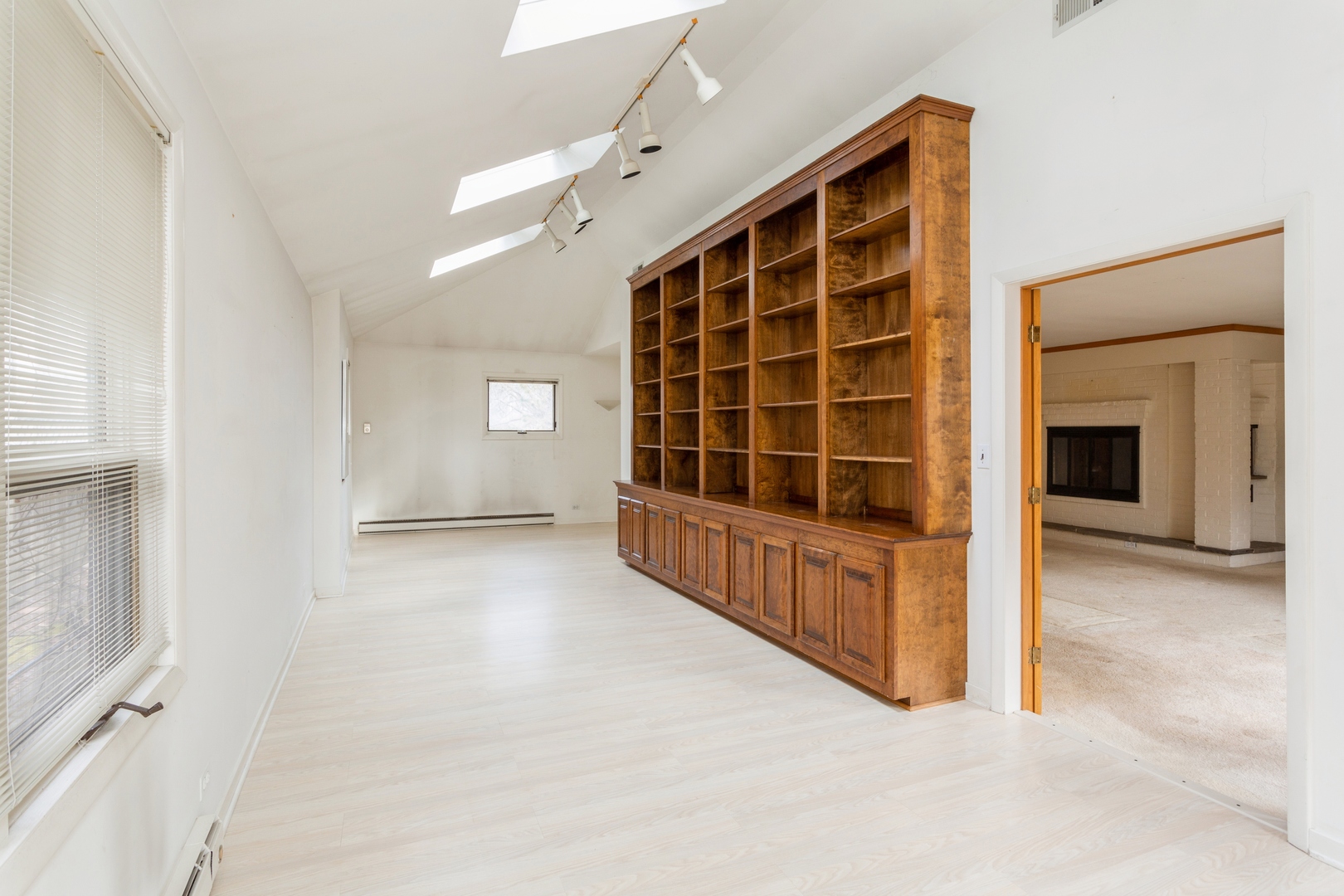 2758 Sheridan Road Evanston, IL 60201 - Photo 8 of 17 a view of an empty room with a fireplace and windows