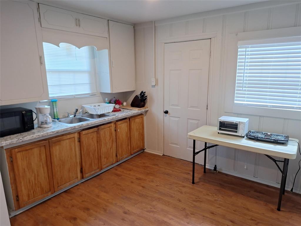 2312 Fincher Road Haltom City, TX 76117 - Photo 5 of 13 a view of a workspace with furniture and wooden floor