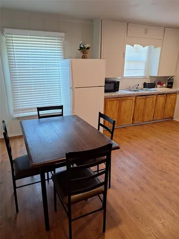 a view of a kitchen with a table and chairs