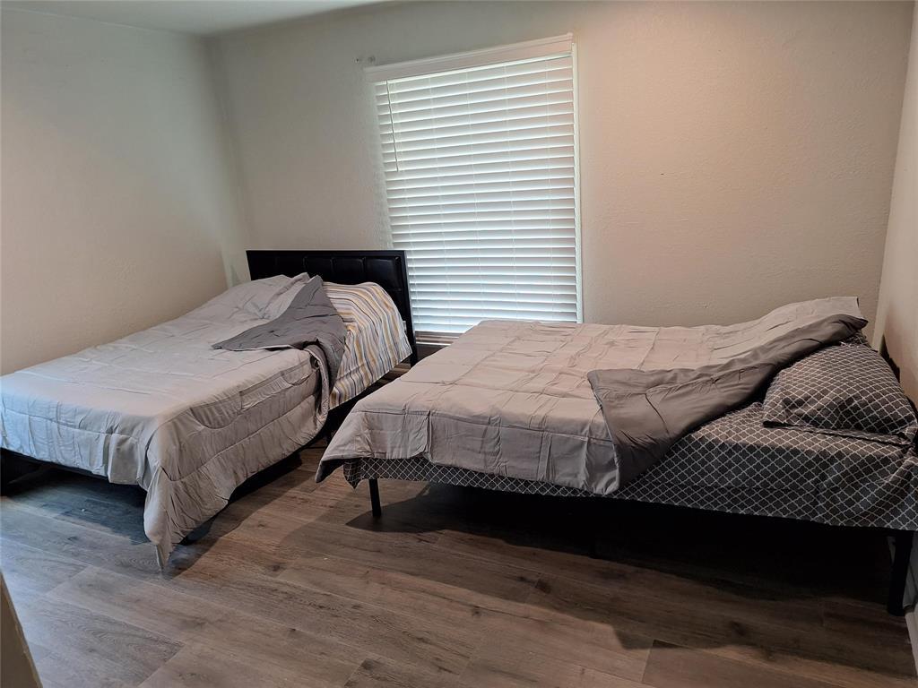 2312 Fincher Road Haltom City, TX 76117 - Photo 9 of 13 a bedroom with a bed and a window