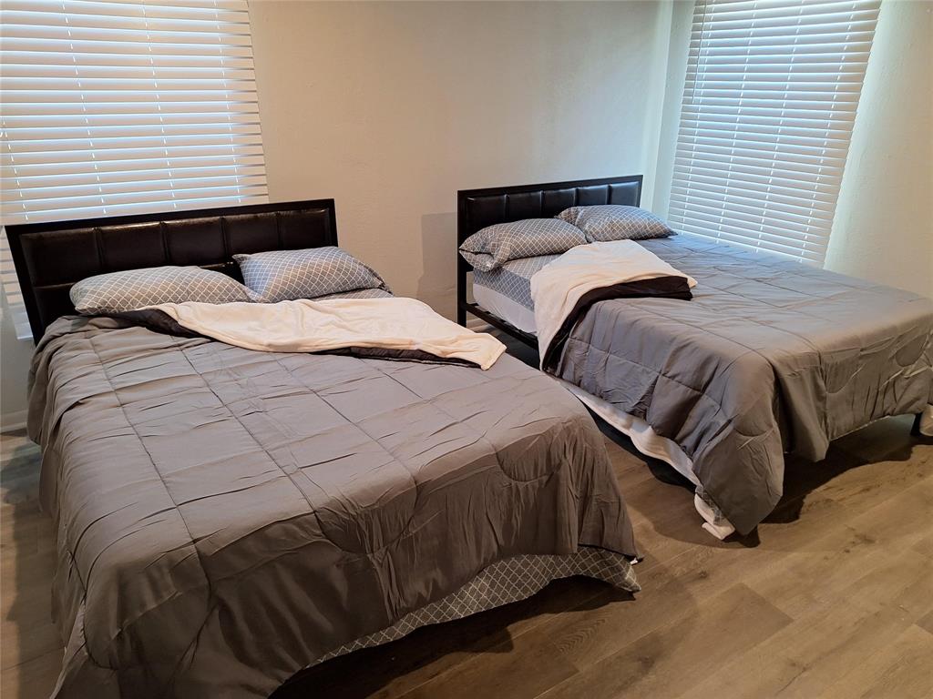 2312 Fincher Road Haltom City, TX 76117 - Photo 10 of 13 a bedroom with two beds and a night stand