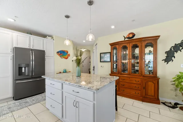 a kitchen with refrigerator and cabinets