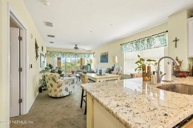 a large bedroom with a bed and a chandelier