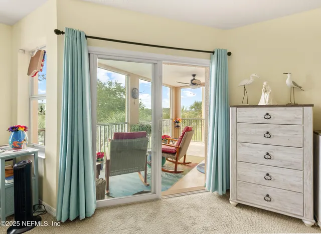 a living room with furniture and a floor to ceiling window