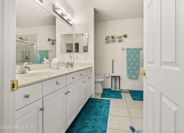 a bathroom with a toilet sink and shower