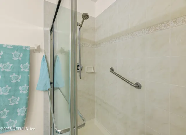 a spacious bathroom with a double vanity sink a mirror and a shower