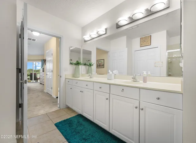 a view of walk in closet with clothes