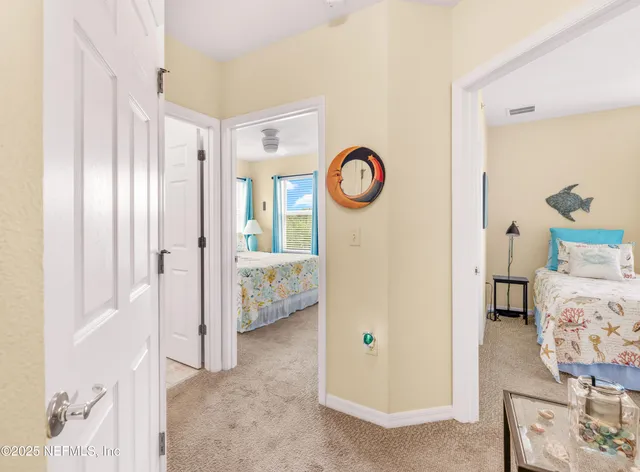 a bedroom with two beds and a chandelier