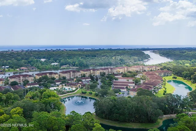 an aerial view of a house with garden space and street view