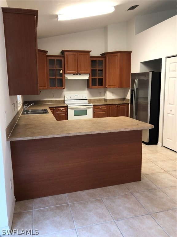 18327 Heather Road Fort Myers, FL 33967 - Photo 4 of 15 a room with stainless steel appliances wooden cabinets and a counter top space