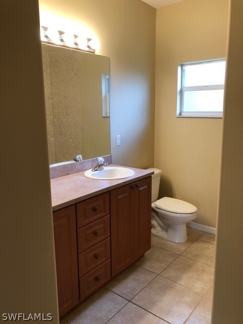 18327 Heather Road Fort Myers, FL 33967 - Photo 10 of 15 a bathroom with a toilet sink and mirror