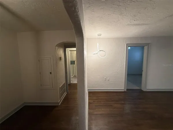 a view of a hallway with wooden floor and closet