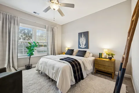 a bedroom with a bed and a chandelier