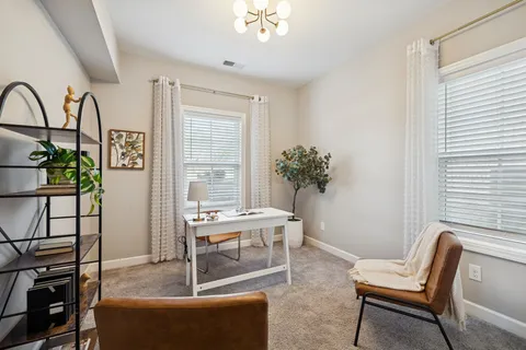a view of a livingroom with furniture and window