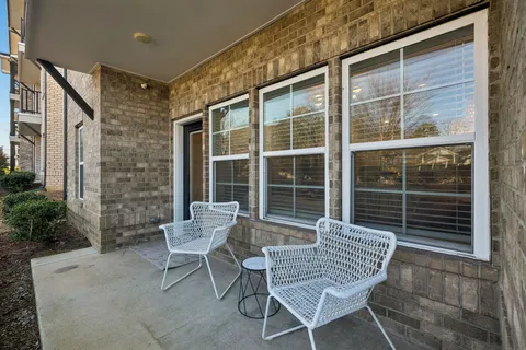 a view of a chair and table in the backyard