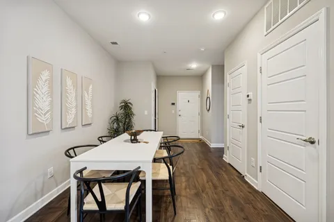 a view of a dining room with furniture and wooden floor
