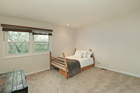 a spacious bedroom with a bed and a window