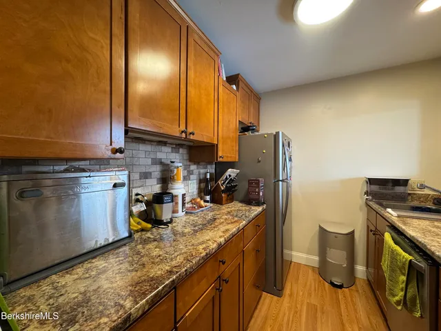a kitchen with sink cabinets and stove top oven