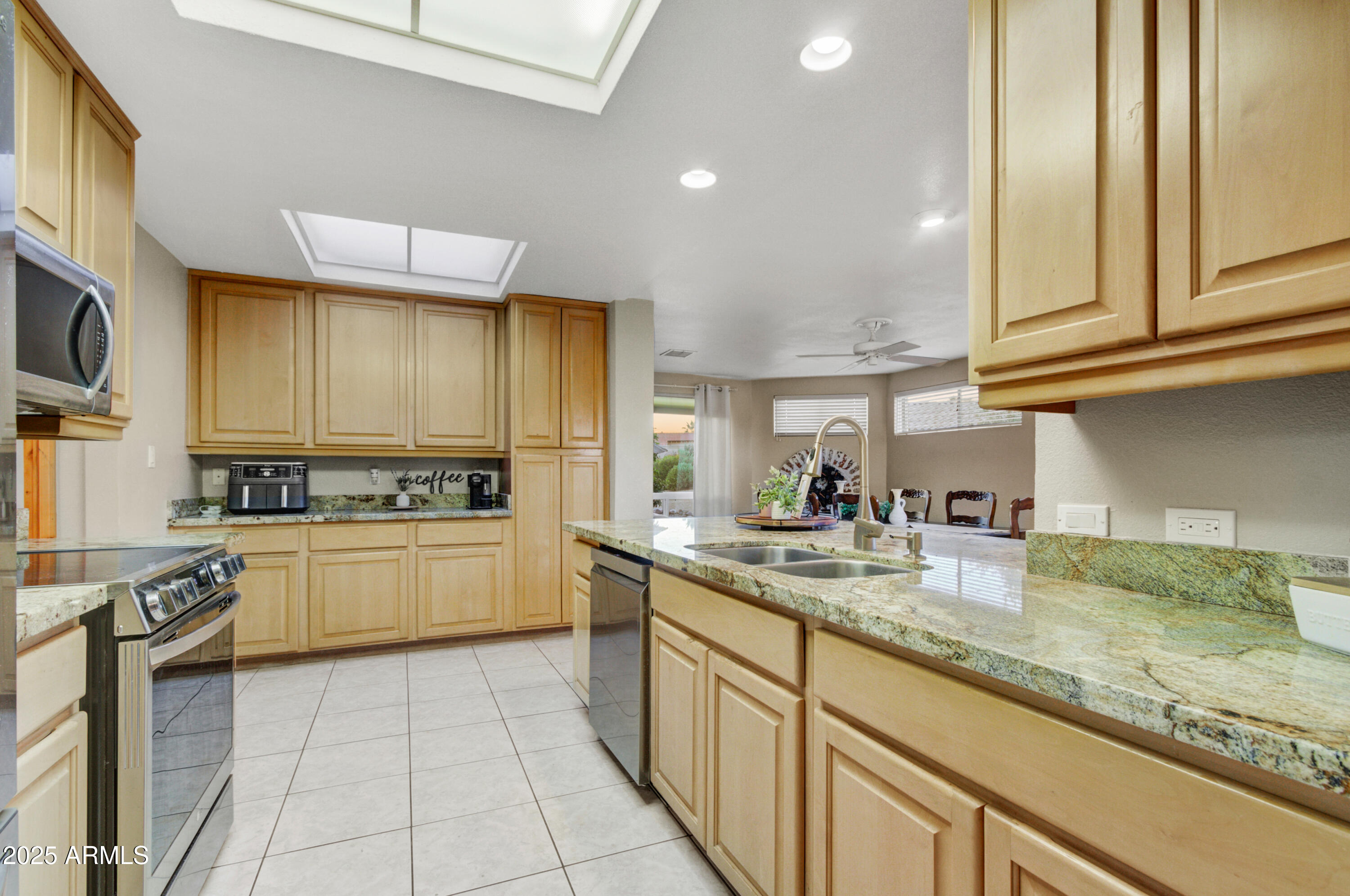 25828 North Primo Circle Rio Verde, AZ 85263 - Photo 5 of 21 a kitchen with a sink a stove cabinets and a wooden floor