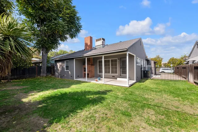 a view of a house with a yard and sitting area